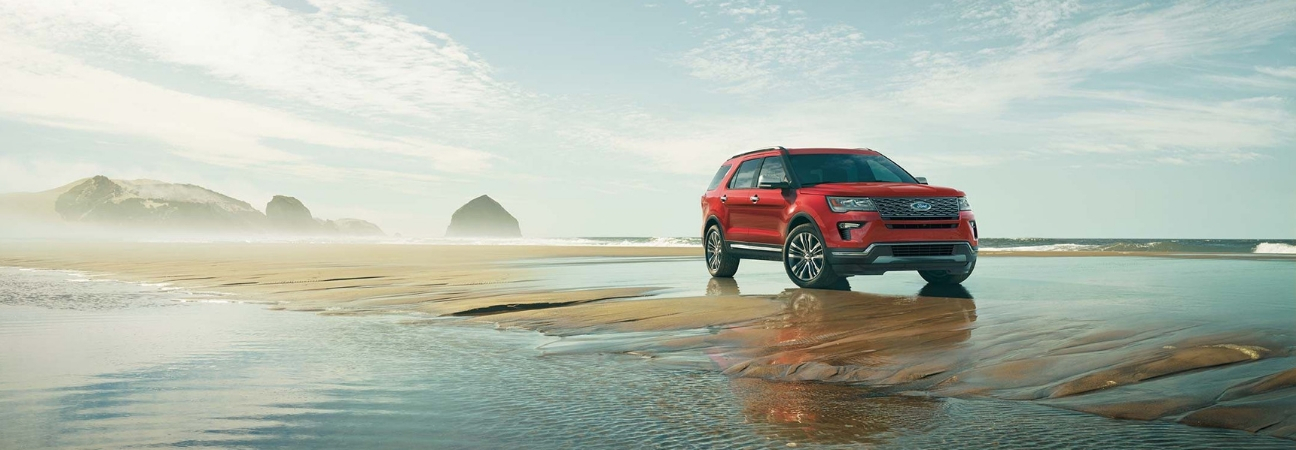 Red 2018 Ford Explorer parked oceanside.
