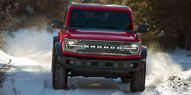 Red 2025 Ford Bronco Sport driving through snow in Princeton, IL